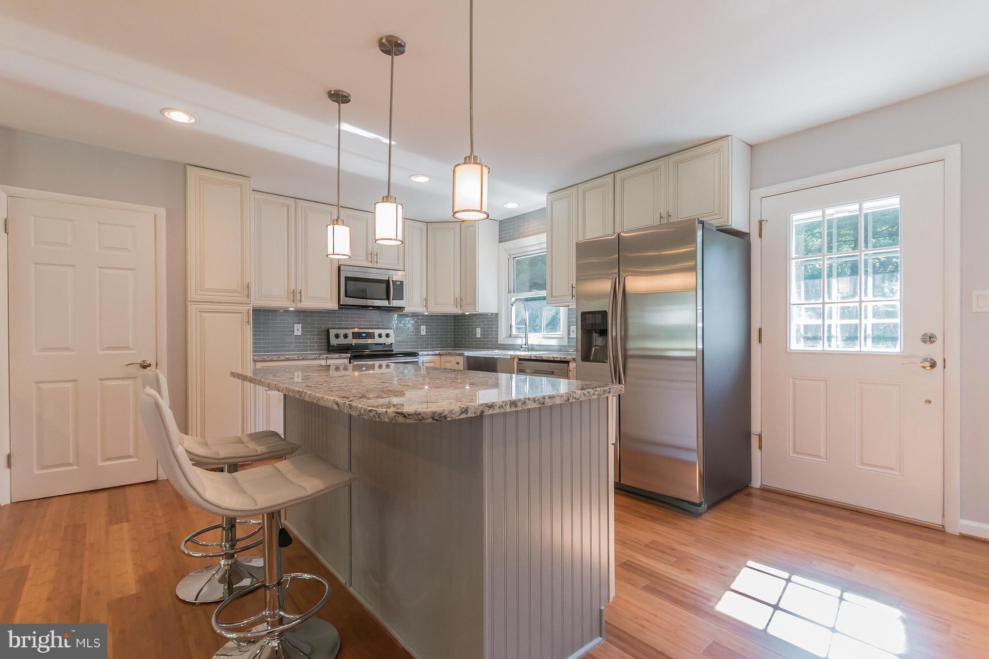1715 Ballenger Creek Pike Point of Rocks, MD 21777 - Photo 11 of 30 Kitchen island matches the glass backsplash