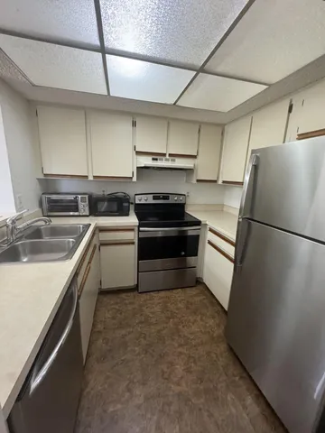 a kitchen with a sink appliances and cabinets