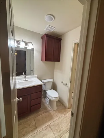 a bathroom with a sink and mirror with toilet