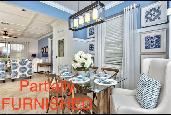 a view of a dining room with furniture and chandelier