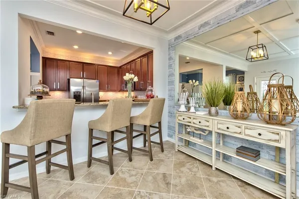 a kitchen with granite countertop wooden cabinets stainless steel appliances and a counter space