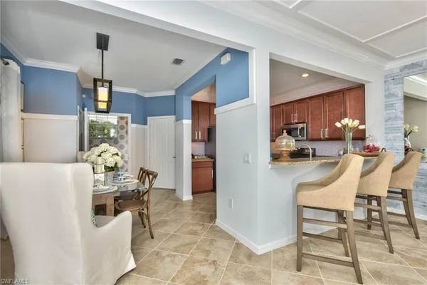 a kitchen with granite countertop stainless steel appliances and wooden cabinets