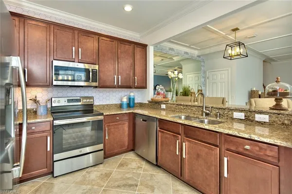 a view of a dining room with furniture and a chandelier