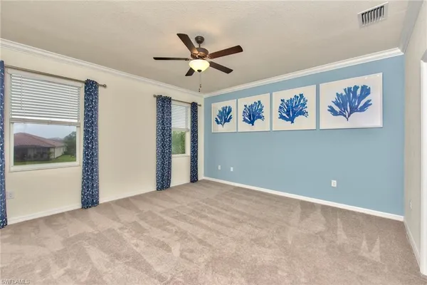 a view of a livingroom with a ceiling fan and window