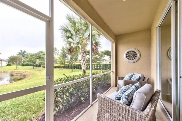 a view of a balcony with floor to ceiling windows with wooden floor