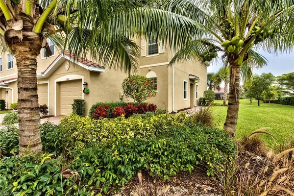 a view of a house with a swimming pool and sitting area