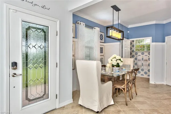 a dining room with furniture and window