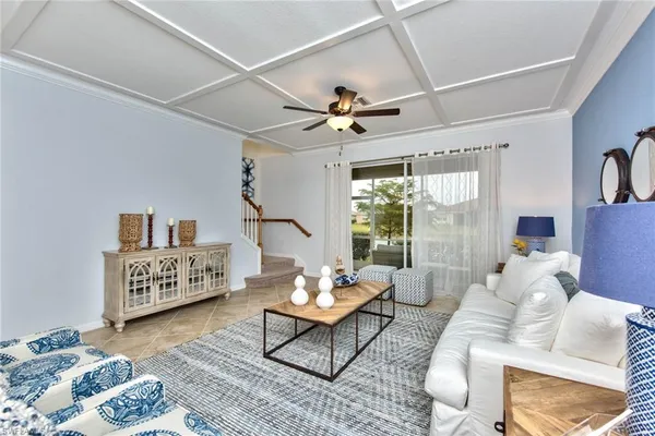 a living room with furniture and a ceiling fan