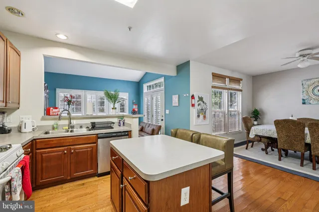 a kitchen with a stove a table and chairs in it