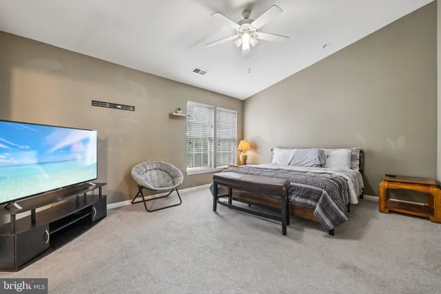 a spacious bedroom with a bed and glass wall