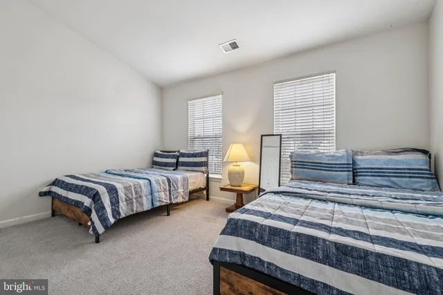 a spacious bedroom with a bed and a window