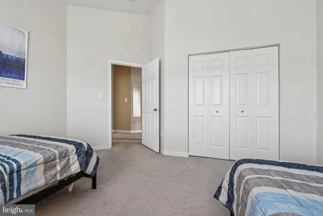 a view of a bedroom with bed and closet