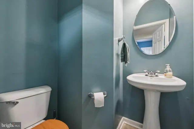 a bathroom with a toilet sink and mirror