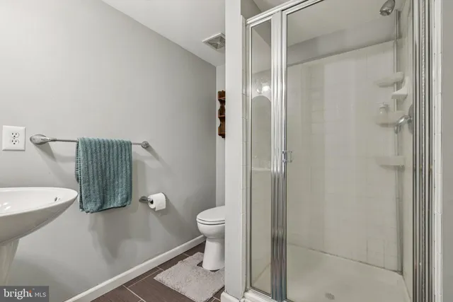 a bathroom with a shower and a toilet