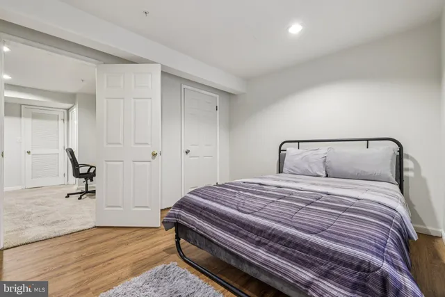 a bedroom with a bed and wooden floor