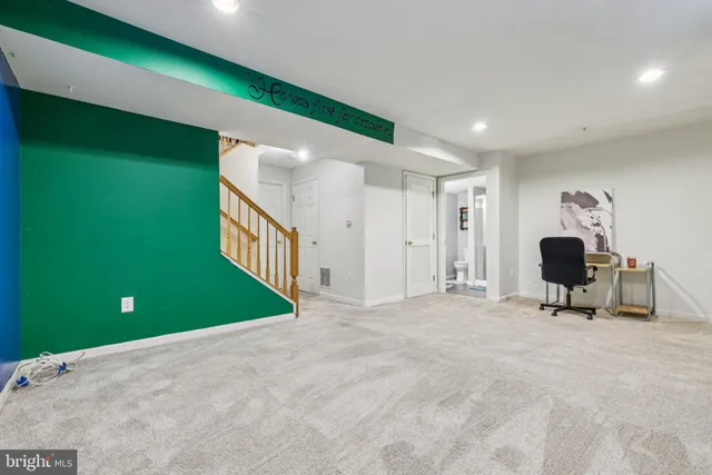 a view of a livingroom with a chair and a fireplace