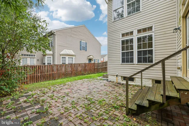 a view of a backyard with a chair and the house