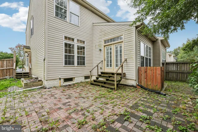 a view of a house with backyard and a chair