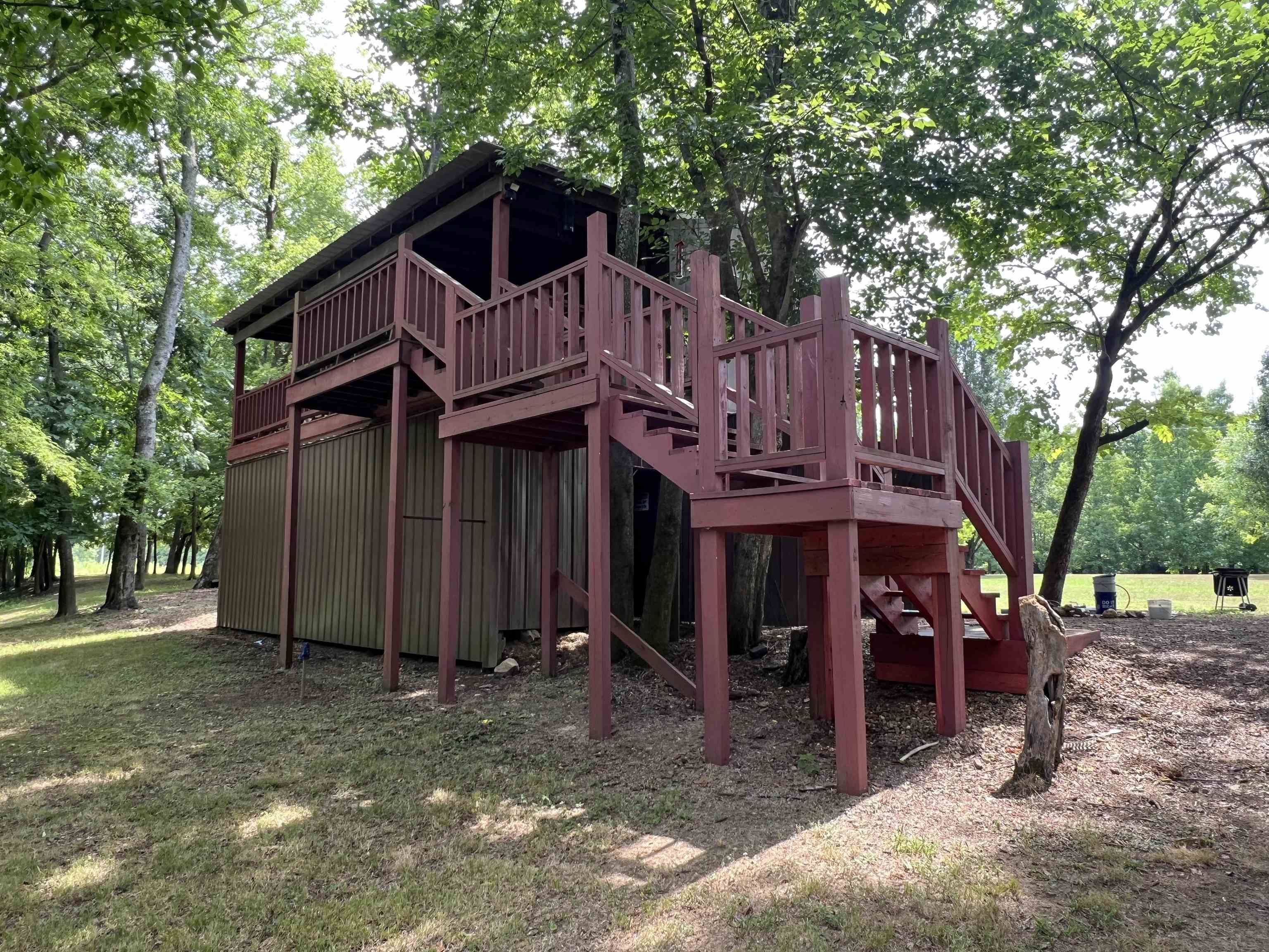590 Towboat Lane Adamsville, TN 38310 - Photo 15 of 39 a view of a house with a yard and large tree