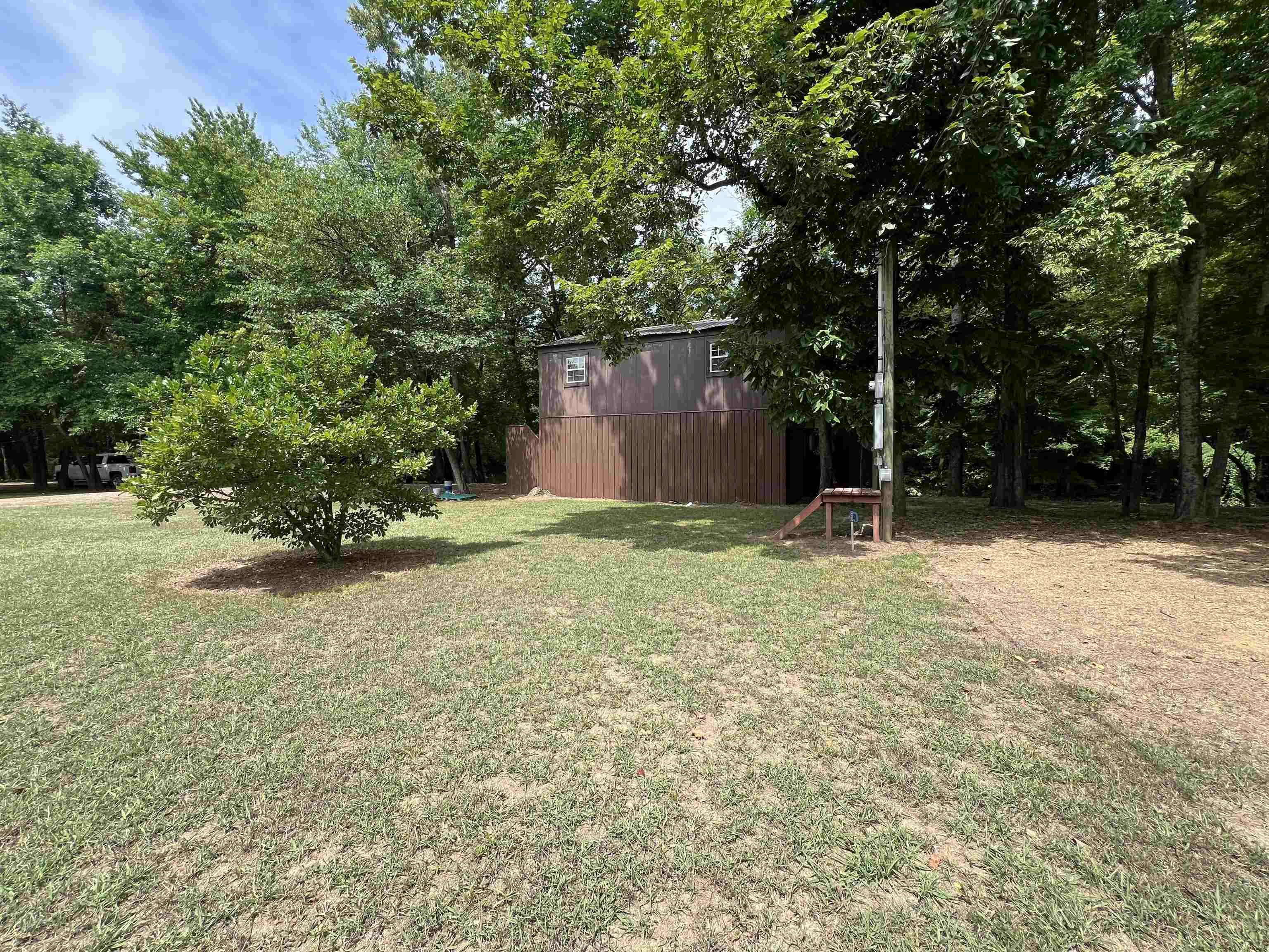590 Towboat Lane Adamsville, TN 38310 - Photo 17 of 39 a backyard of a house with lots of green space