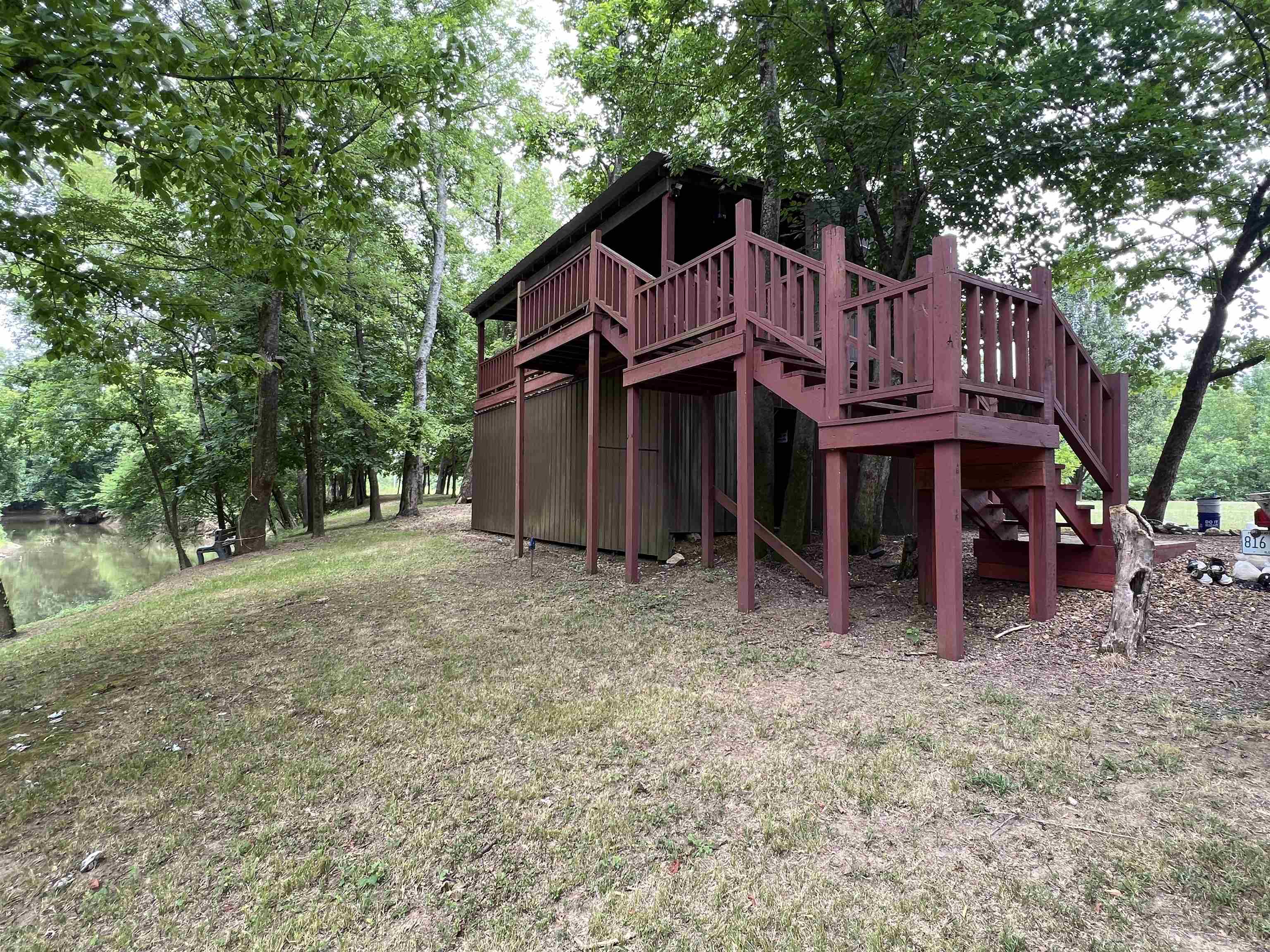 590 Towboat Lane Adamsville, TN 38310 - Photo 19 of 39 a view of a house with a yard and large tree