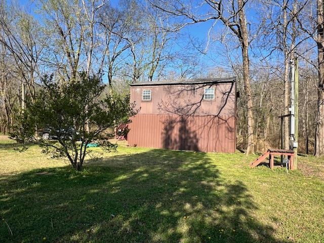 590 Towboat Lane Adamsville, TN 38310 - Photo 20 of 39 a backyard of a house with table and chairs