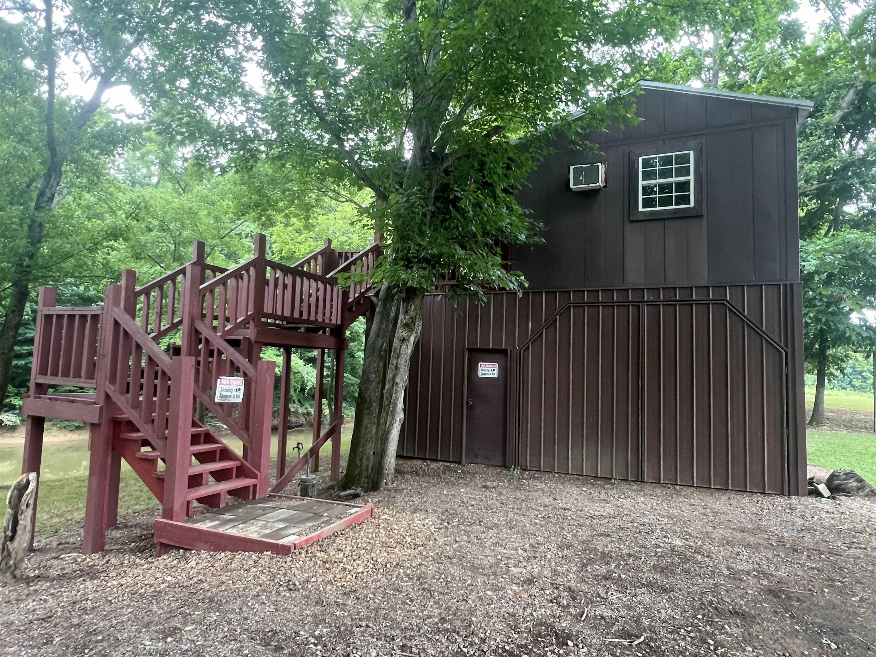590 Towboat Lane Adamsville, TN 38310 - Photo 21 of 39 a view of a house with a yard and wooden fence