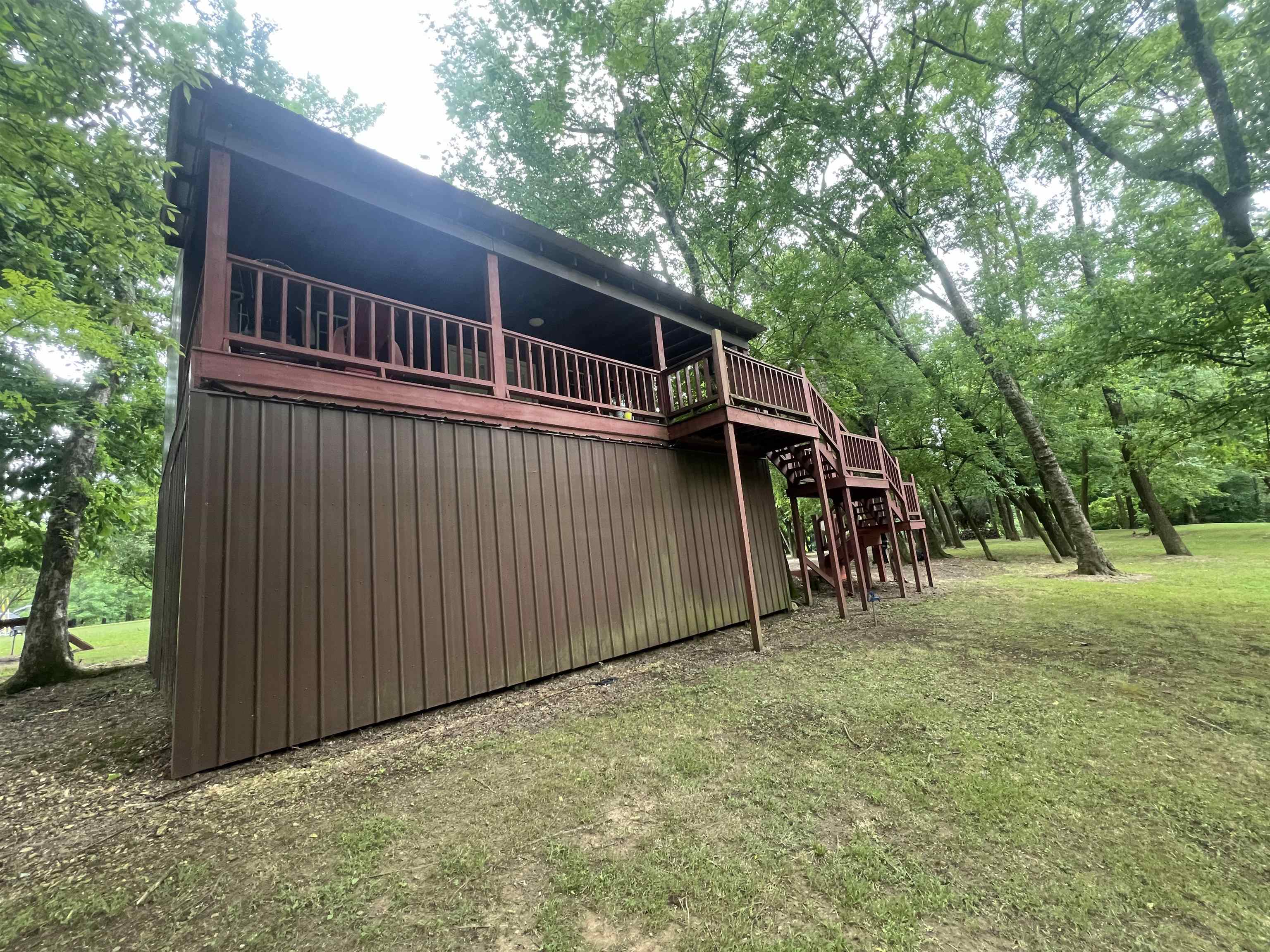 590 Towboat Lane Adamsville, TN 38310 - Photo 23 of 39 a view of backyard with deck and trees