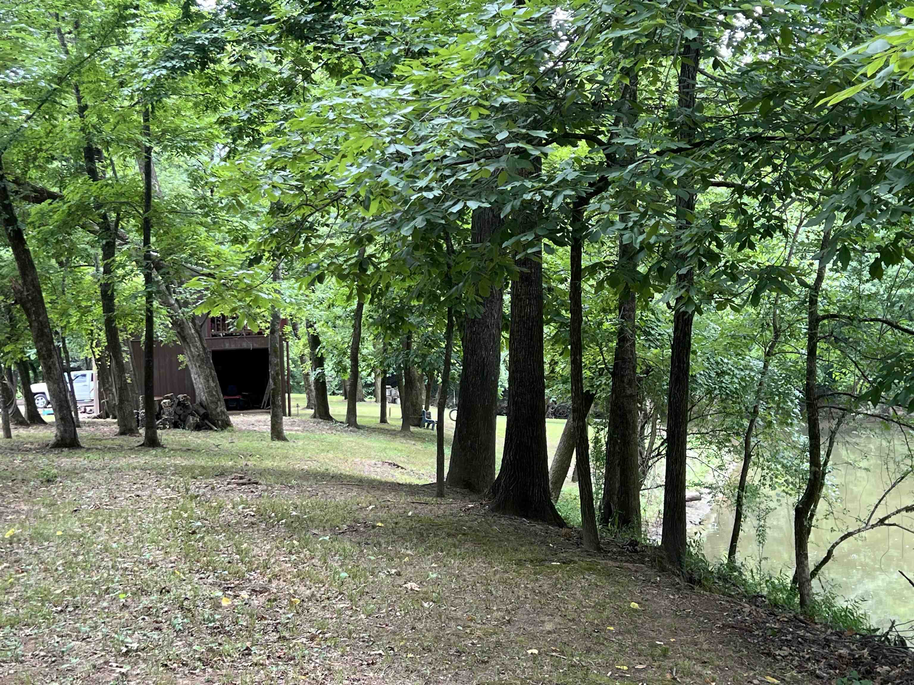 590 Towboat Lane Adamsville, TN 38310 - Photo 31 of 39 a backyard of a house with barbeque oven