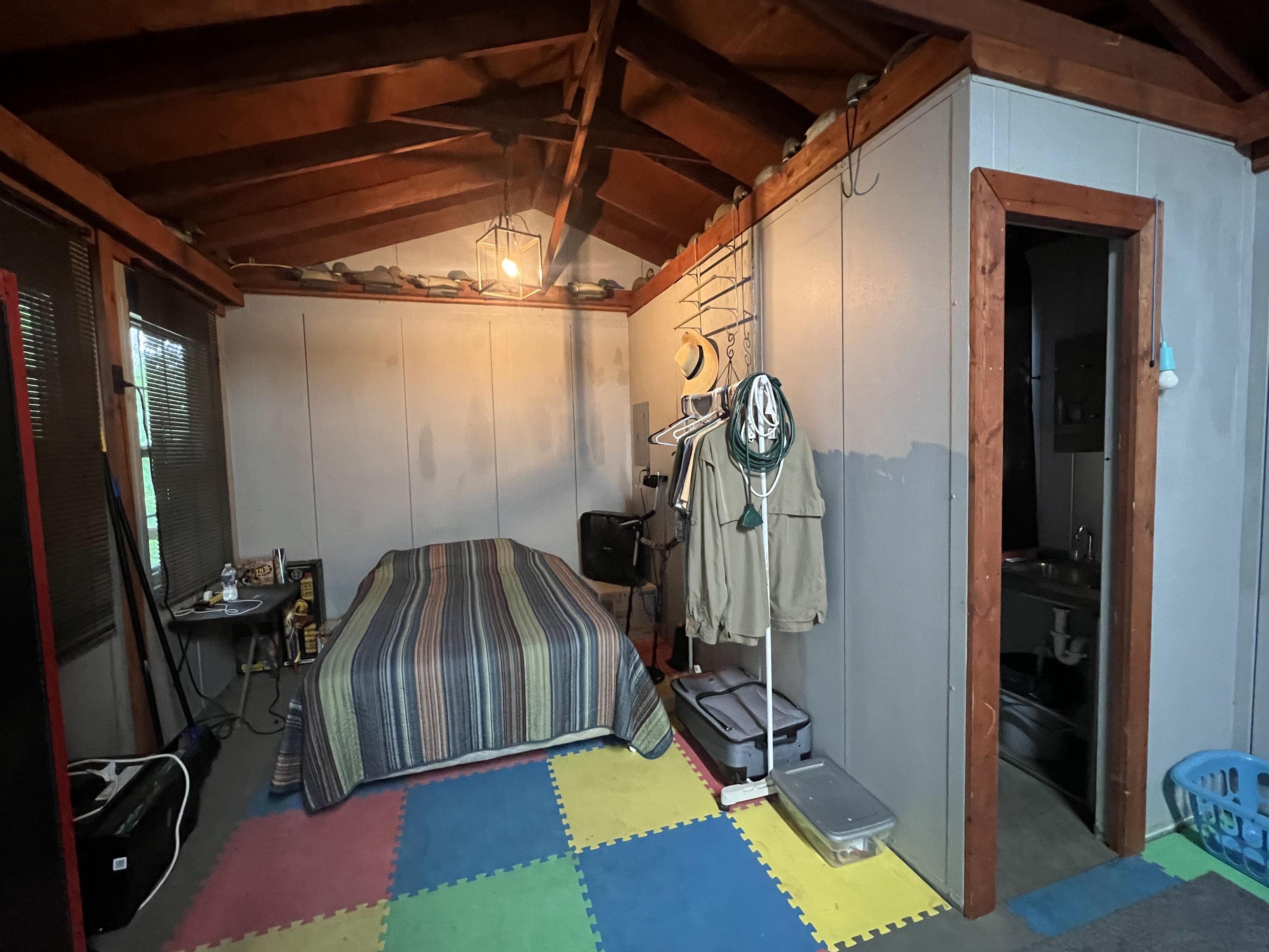 590 Towboat Lane Adamsville, TN 38310 - Photo 6 of 39 Miscellaneous room featuring carpet flooring and lofted ceiling with beams