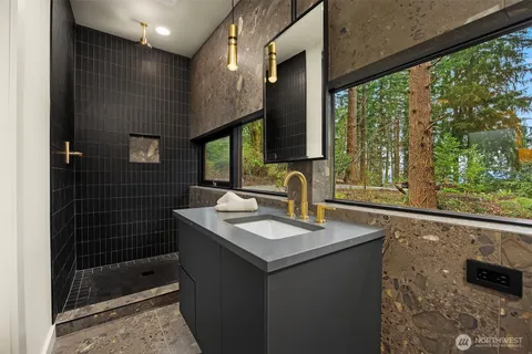 a bathroom with a sink a vanity and a shower