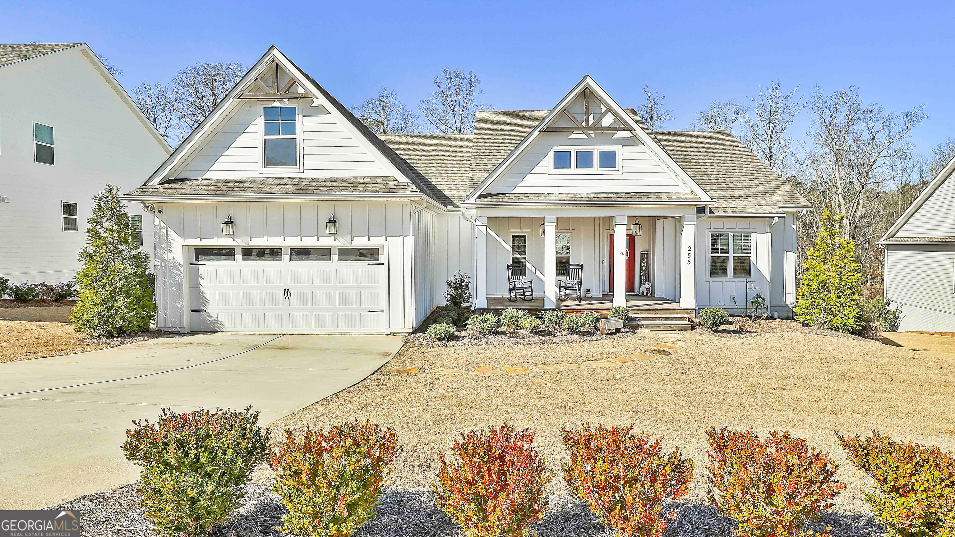 a front view of a house with yard and garage