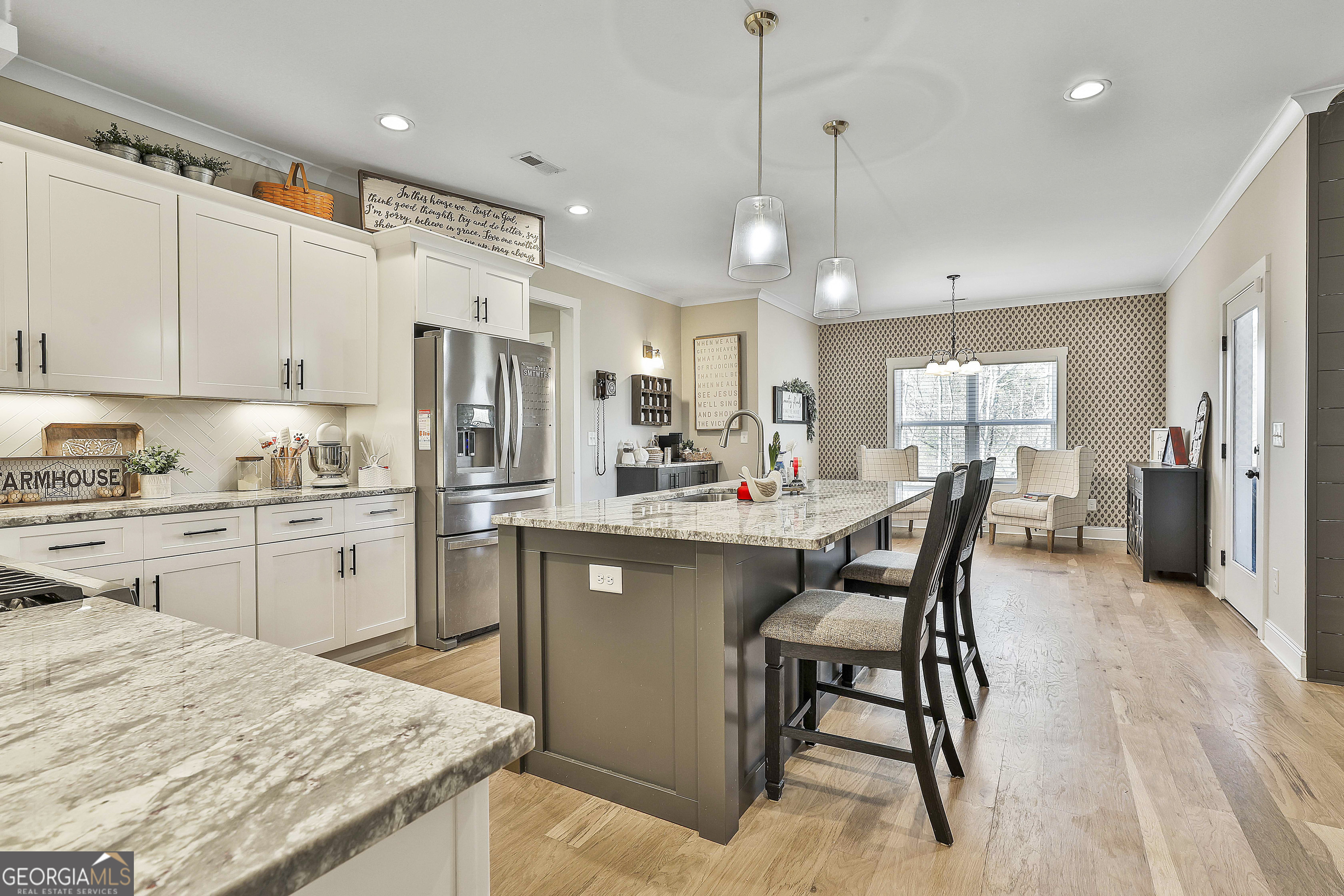 255 Werner Way Senoia, GA 30276 - Photo 20 of 47 a kitchen with kitchen island a dining table chairs sink and cabinets