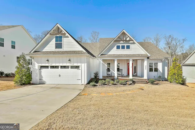 a front view of house with yard outdoor seating and garage