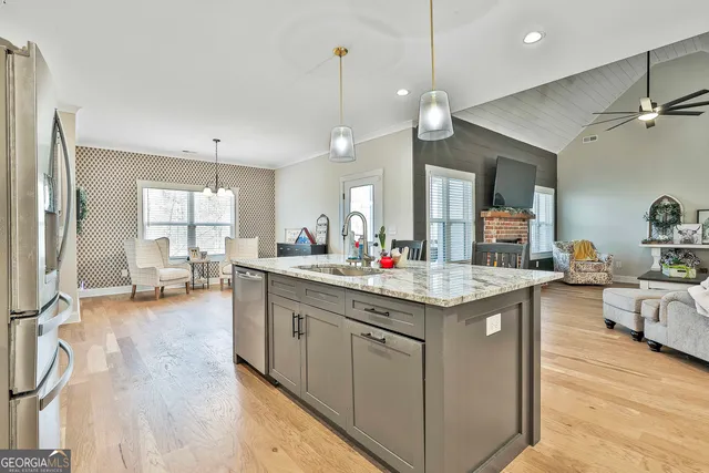 a kitchen with sink stove and cabinets