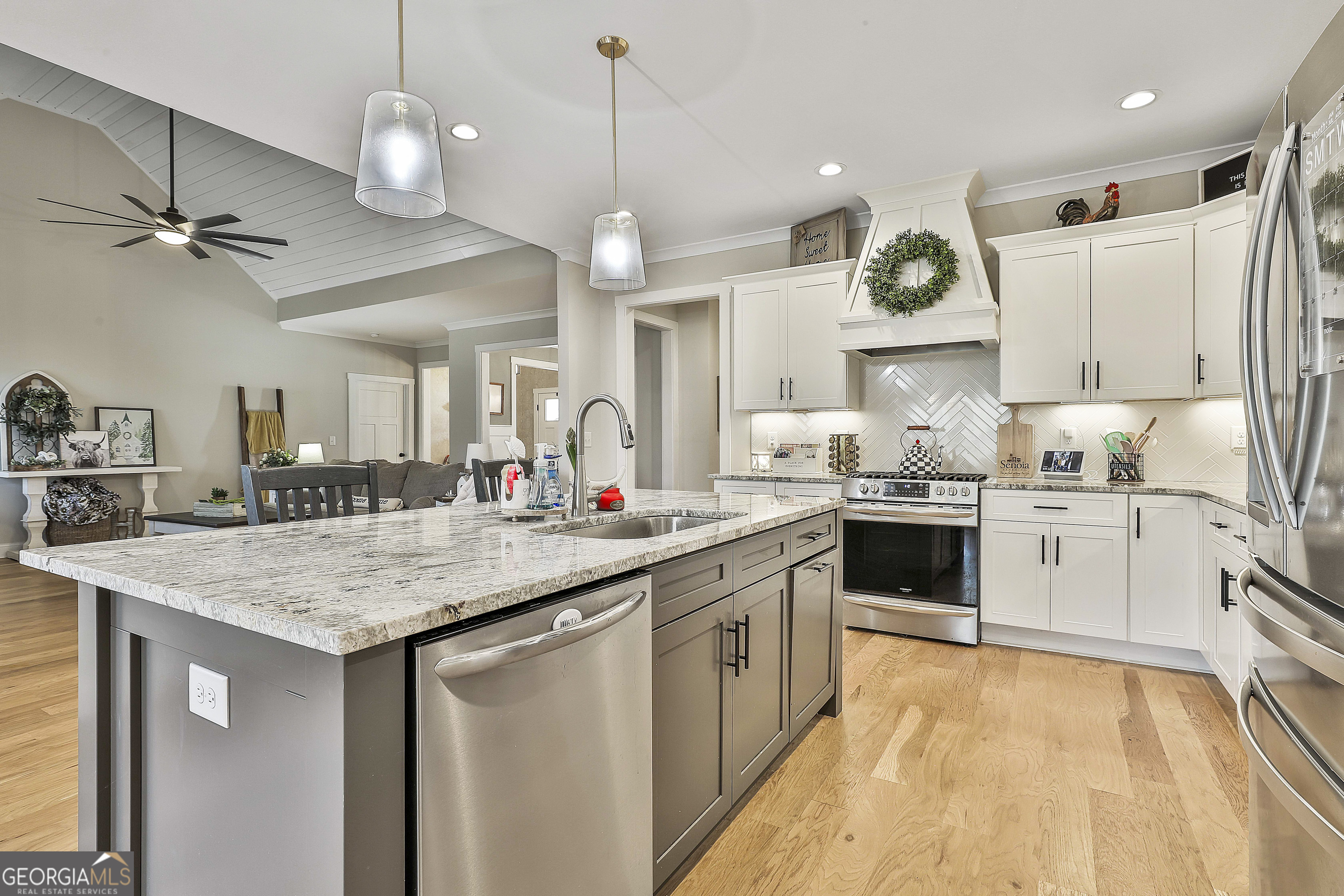 255 Werner Way Senoia, GA 30276 - Photo 26 of 47 a kitchen with a stove a sink a center island and cabinets