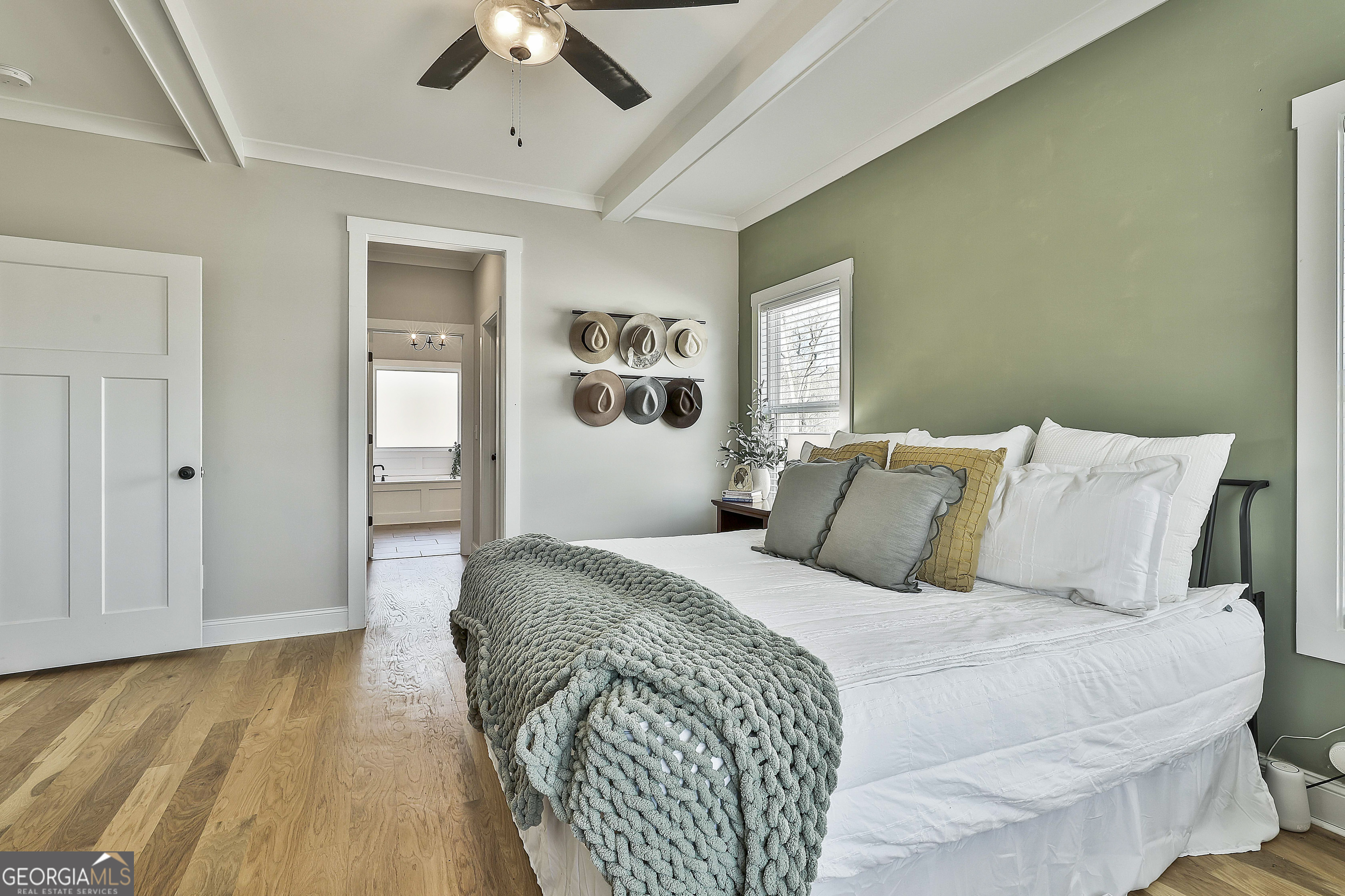 255 Werner Way Senoia, GA 30276 - Photo 29 of 47 a spacious bedroom with a bed and a chandelier