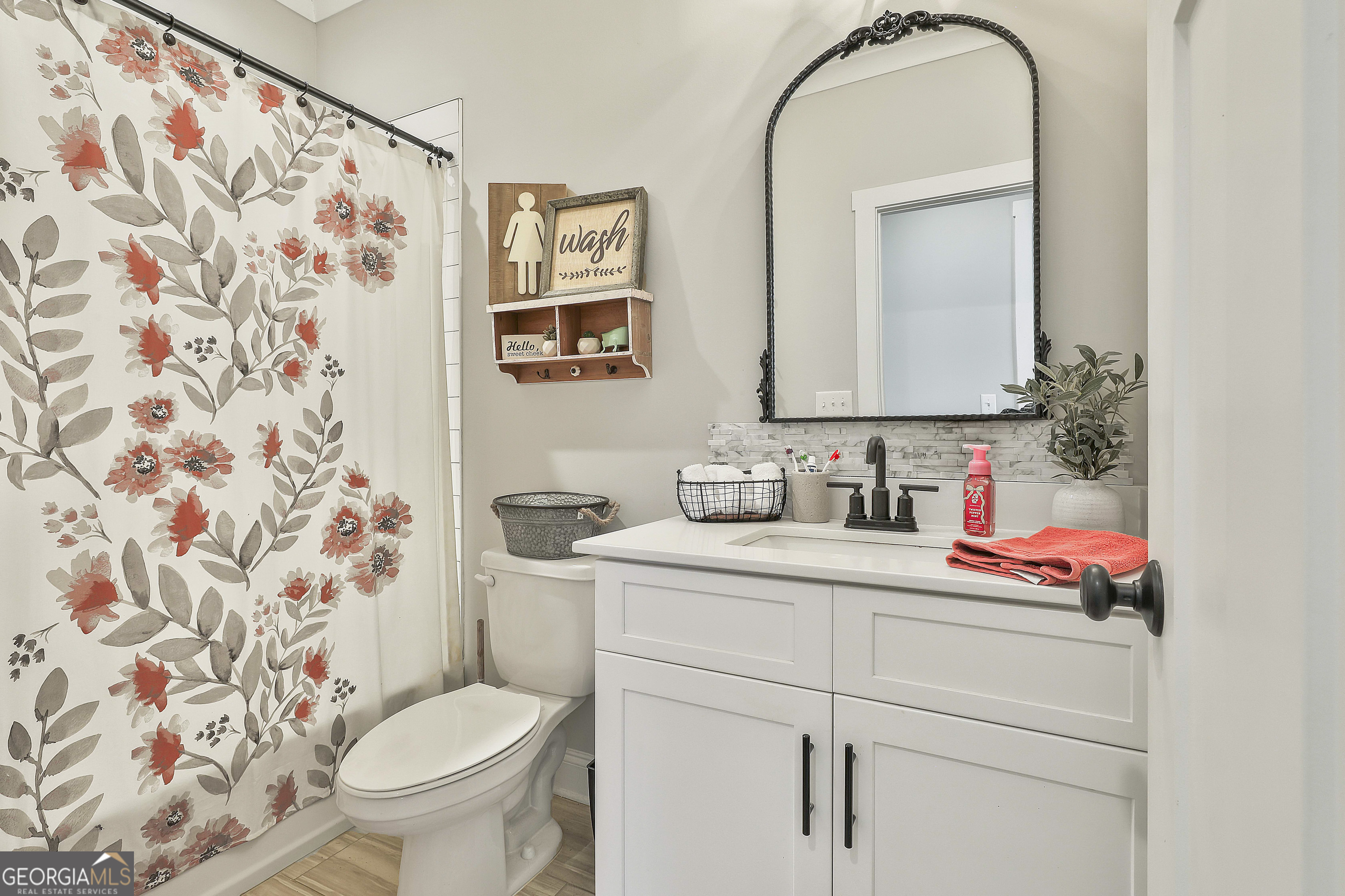 255 Werner Way Senoia, GA 30276 - Photo 34 of 47 a bathroom with a granite countertop sink and a toilet