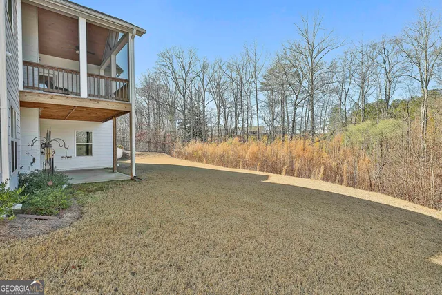 a view of a house with a yard and tree s