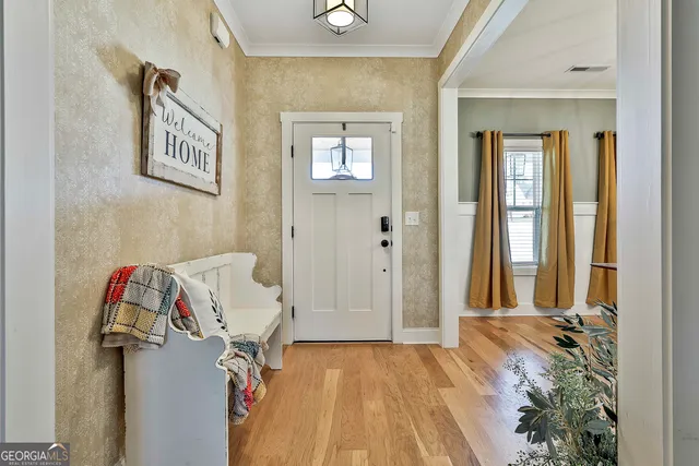 a view of a bedroom with wooden floor and closet