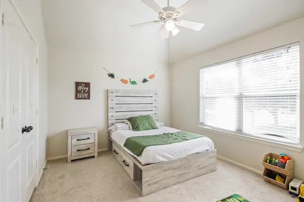 a bedroom with a bed and a tv
