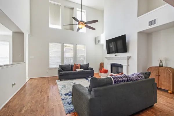 a living room with furniture a fireplace and a flat screen tv