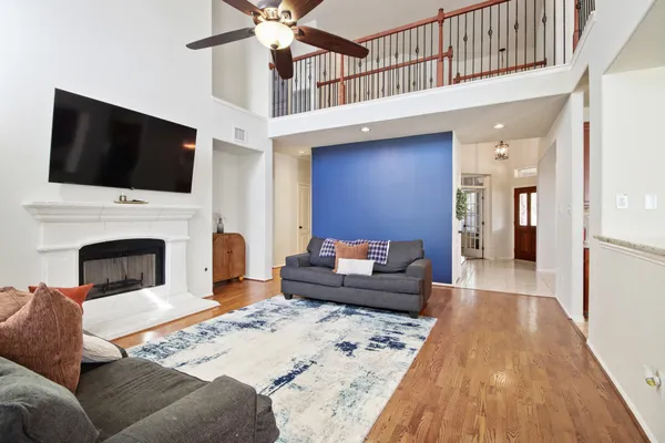 a living room with furniture wooden floor and a fireplace