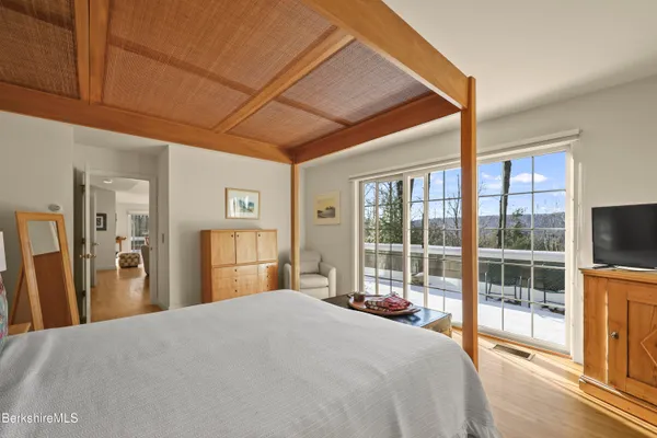 a living room with furniture a rug and wall paintings
