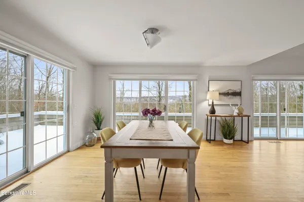 a view of a dining room with furniture window and wooden floor