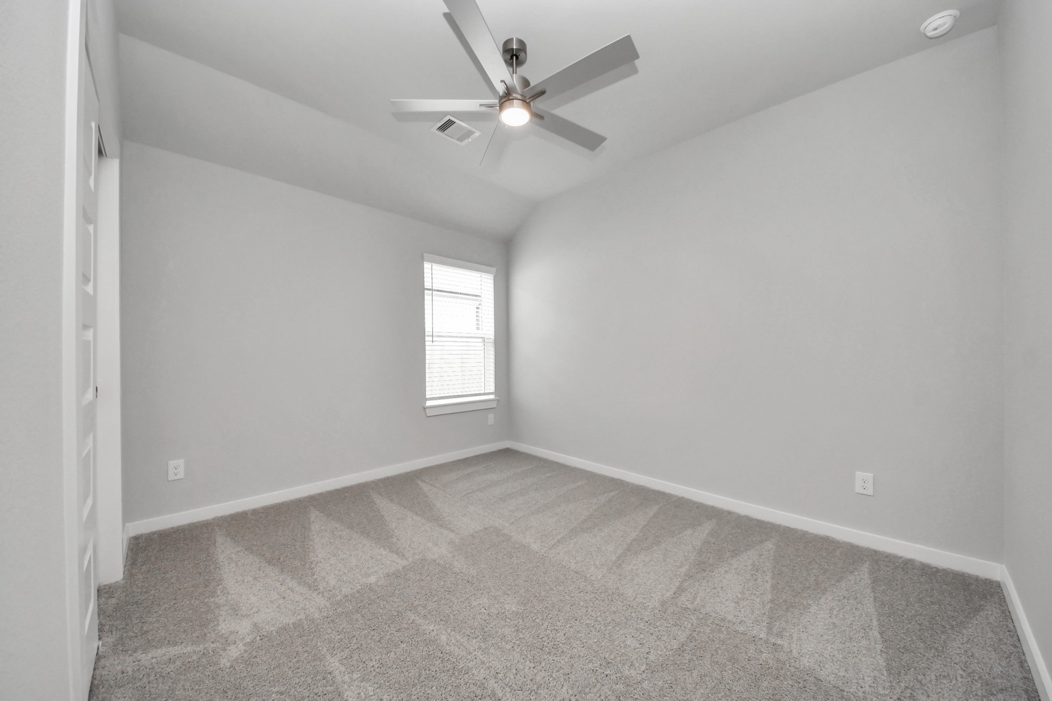 24518 Broad Park Spring, TX 77373 - Photo 8 of 29 Secondary bedroom features plush carpeting, large windows that let in plenty of natural light, bright paint, and spacious closets. Sample photo of completed home with similar floor plan. Actual colors and selections may vary.
