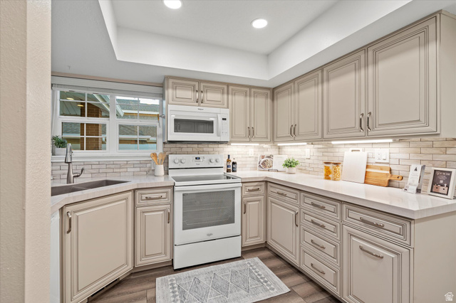 888 East 6895 South Midvale, UT 84047 - Photo 11 of 54 Efficient U-shaped layout with abundant cabinetry and workspace, complemented by modern lighting and a clean, cohesive design.