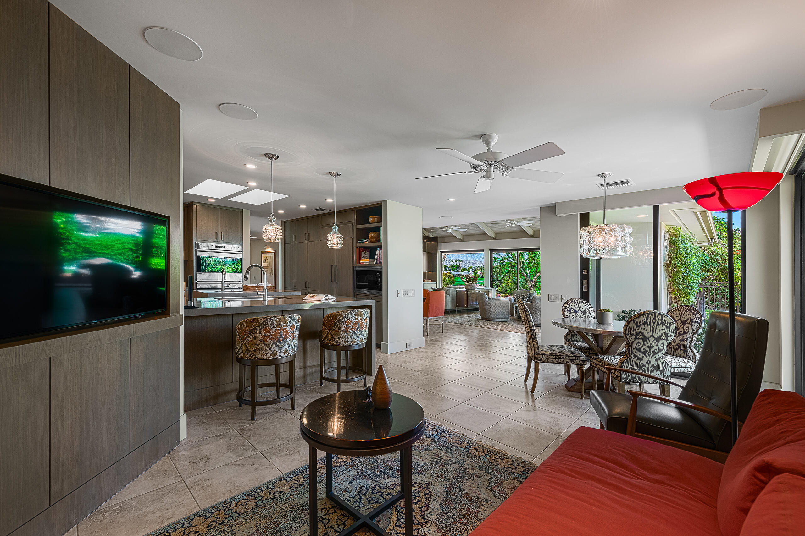 18 Creekside Drive Rancho Mirage, CA 92270 - Photo 11 of 40 a living room with furniture a flat screen tv and kitchen view