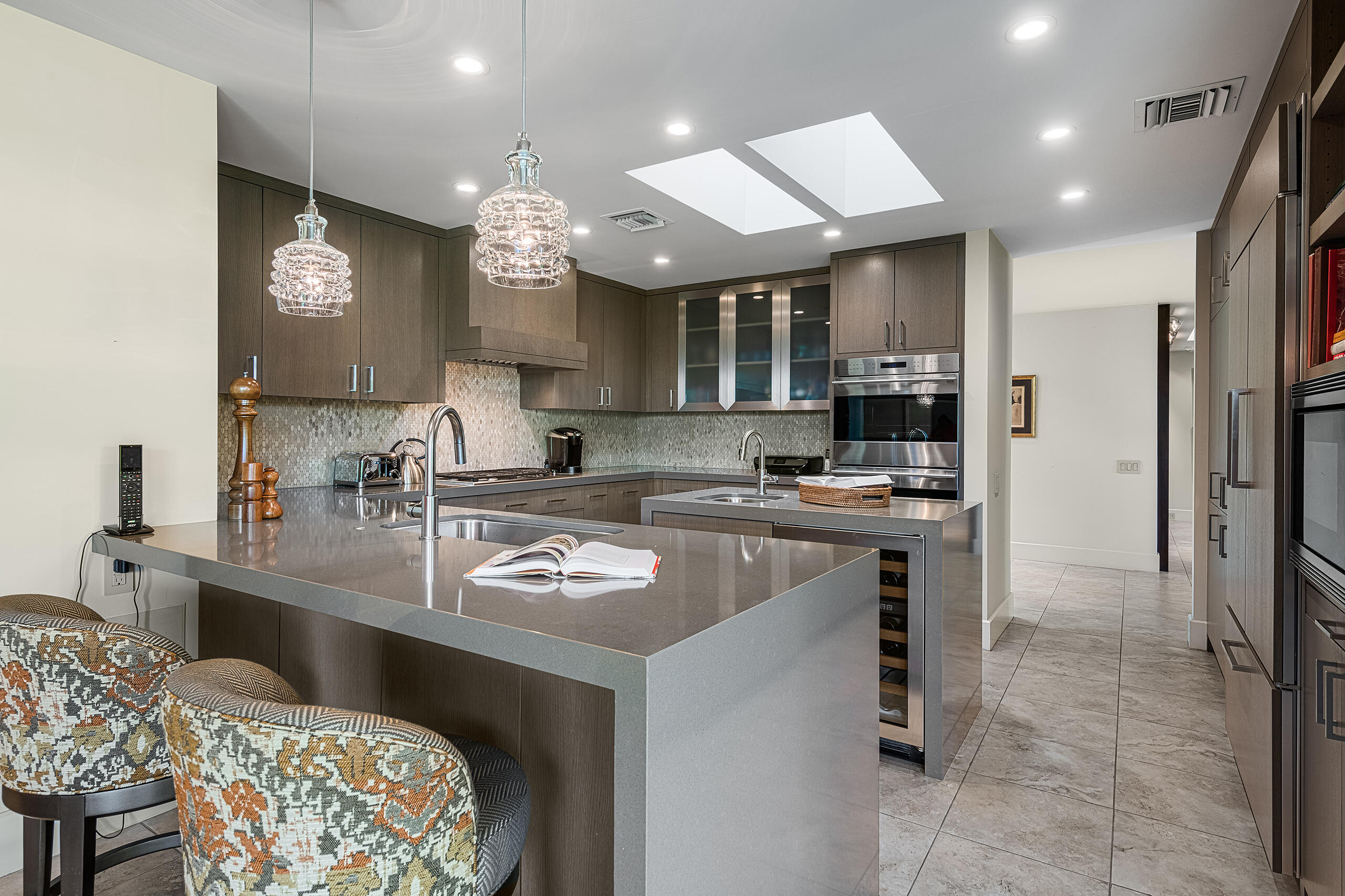 18 Creekside Drive Rancho Mirage, CA 92270 - Photo 12 of 40 a kitchen with kitchen island stainless steel appliances a sink a stove and a refrigerator