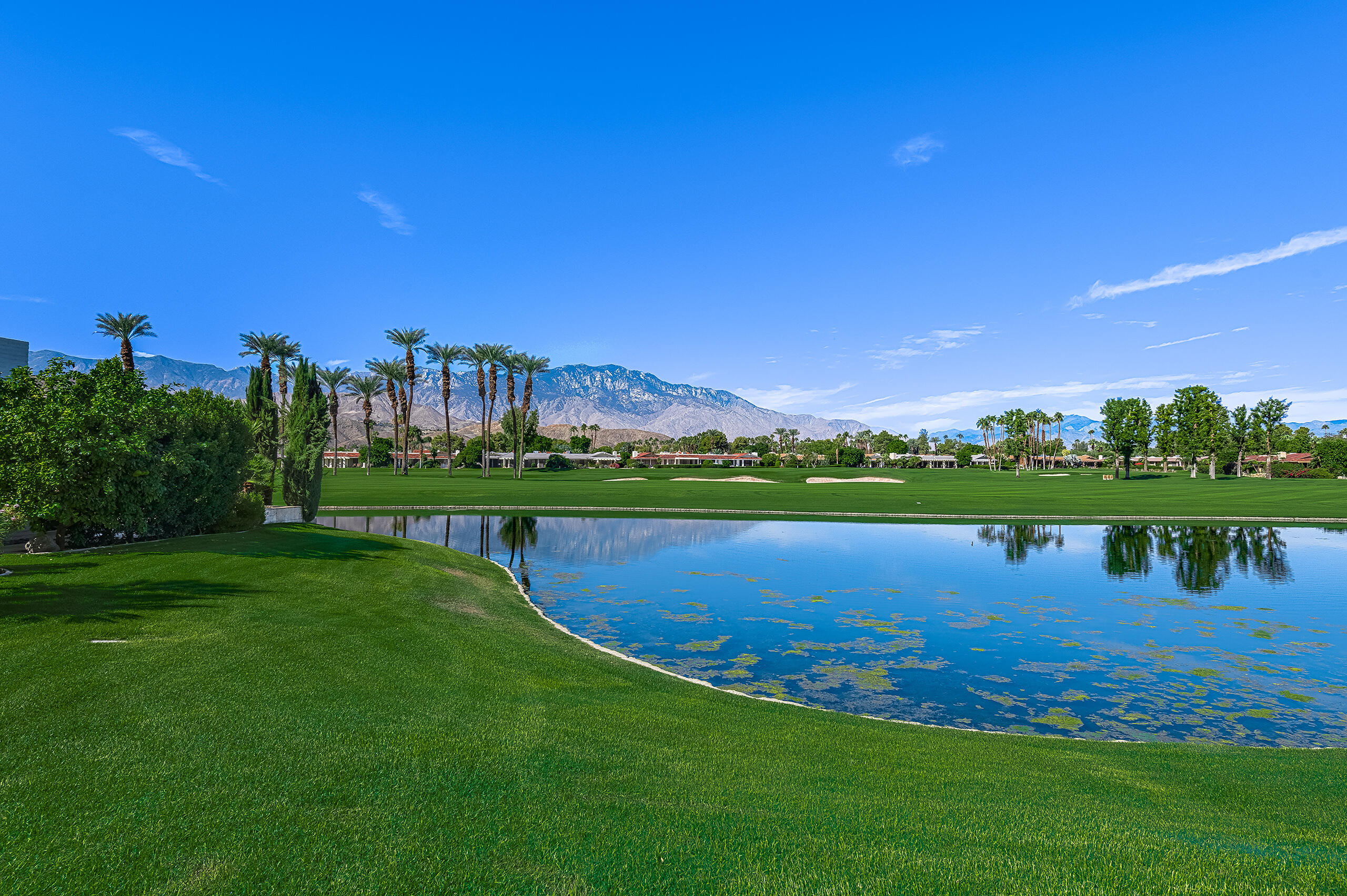 18 Creekside Drive Rancho Mirage, CA 92270 - Photo 22 of 40 a view of a lake with houses in the background